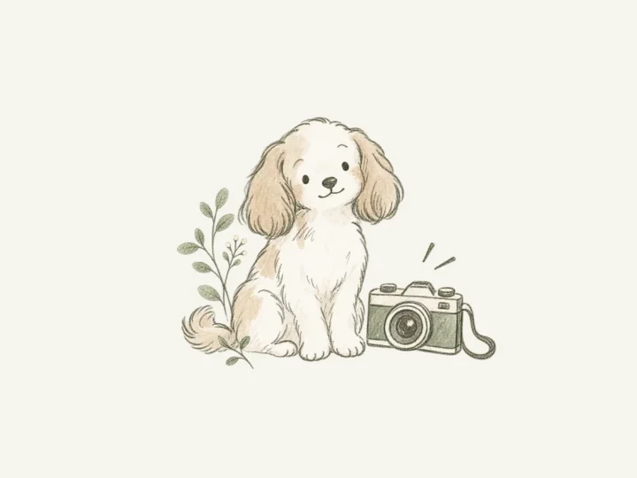 カメラの横に座る子犬のイラスト